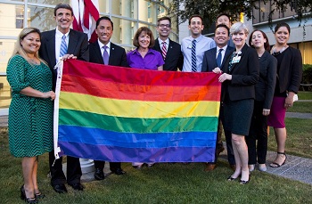 Staff holding a rainbow flag